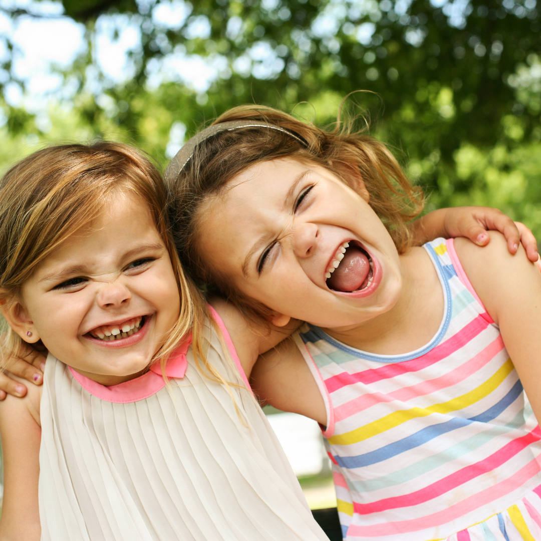 Happy family laughing and eating together outside on a sunny patio